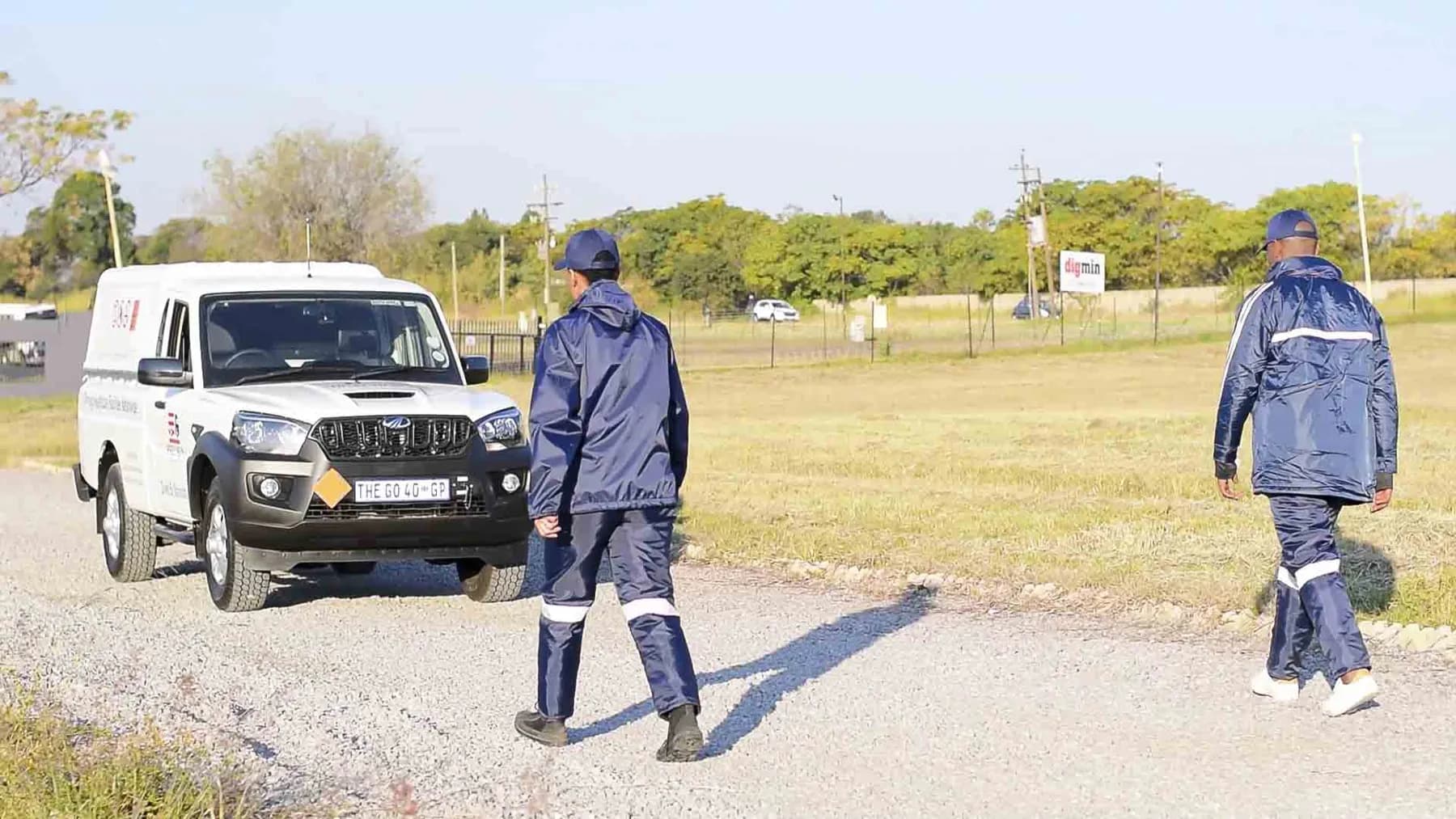 Hazchem crew walking to a branded bakkie