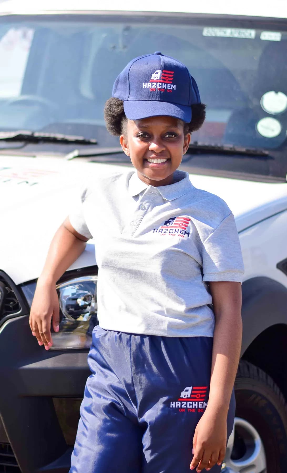 Hazchem crew member in uniform beside a branded vehicle