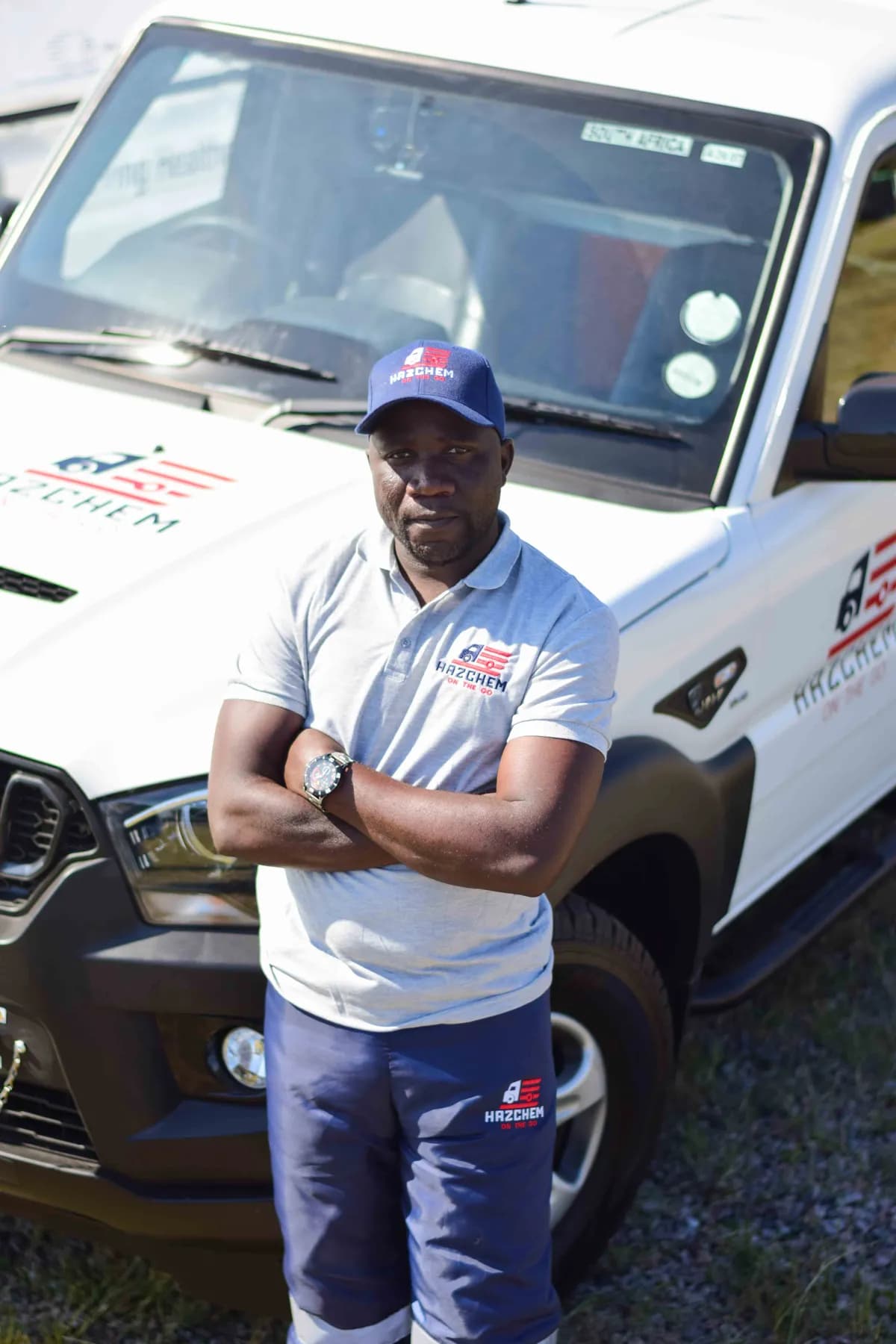 Hazchem crew member in uniform beside a branded vehicle