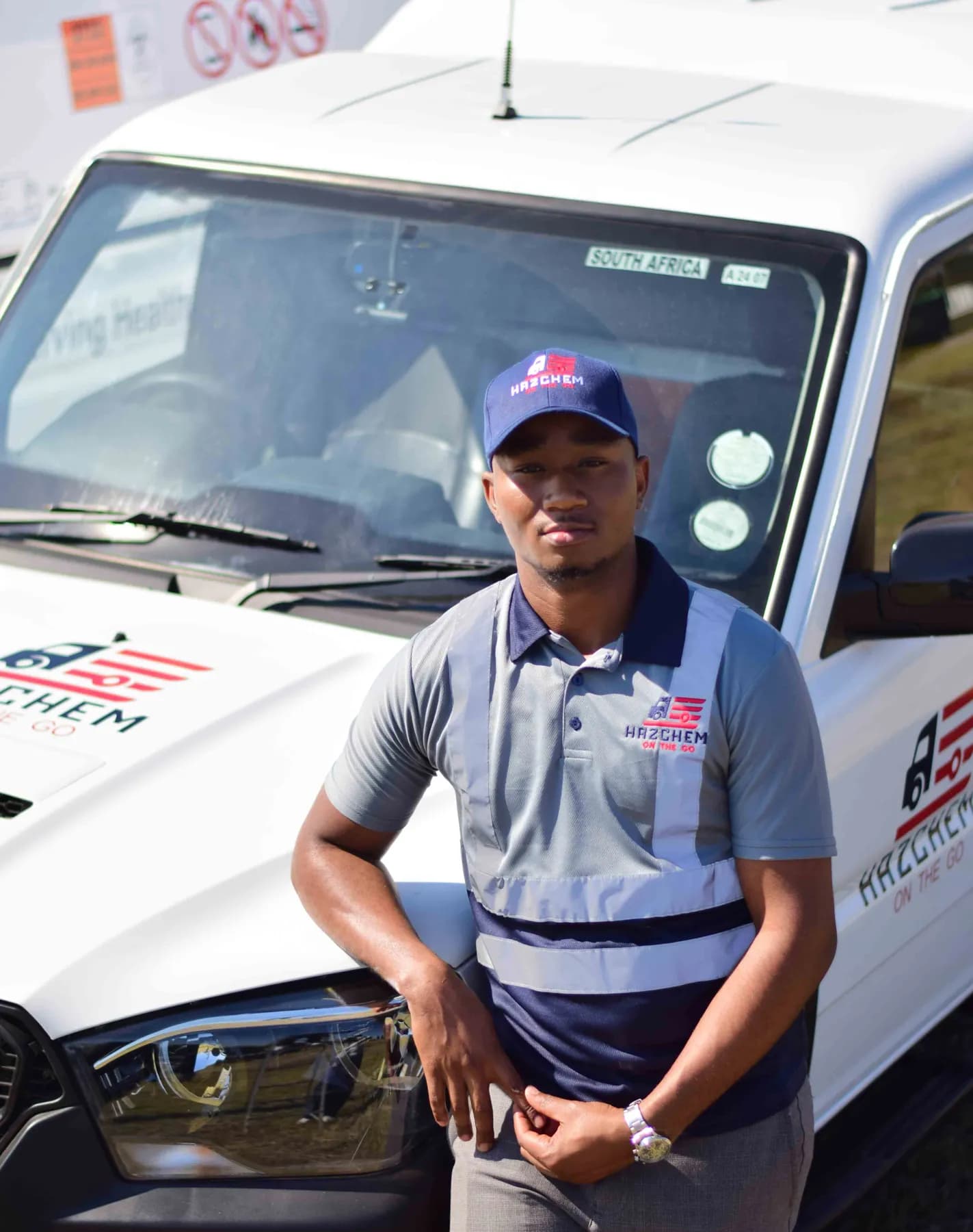 Hazchem crew member in uniform beside a branded vehicle