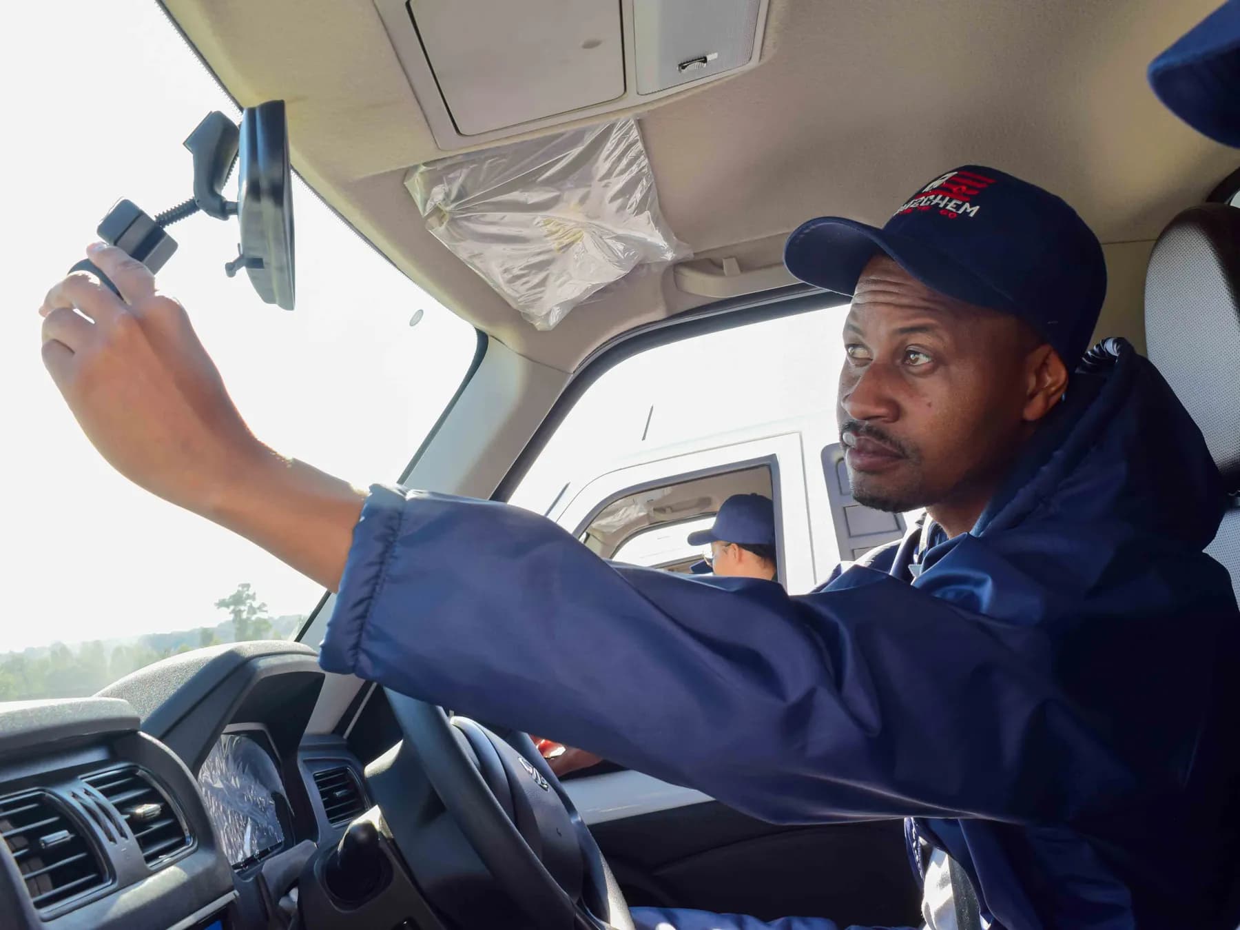 Hazchem driver adjusting the in-cab dashcam before a run