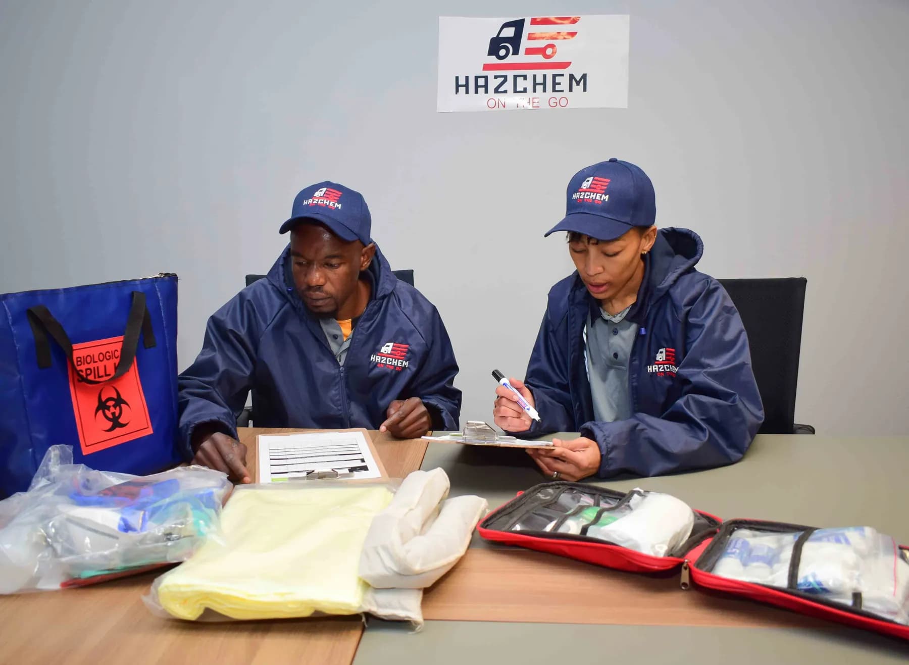 Hazchem crew members checking UN3373 specimen kits and biohazard bags