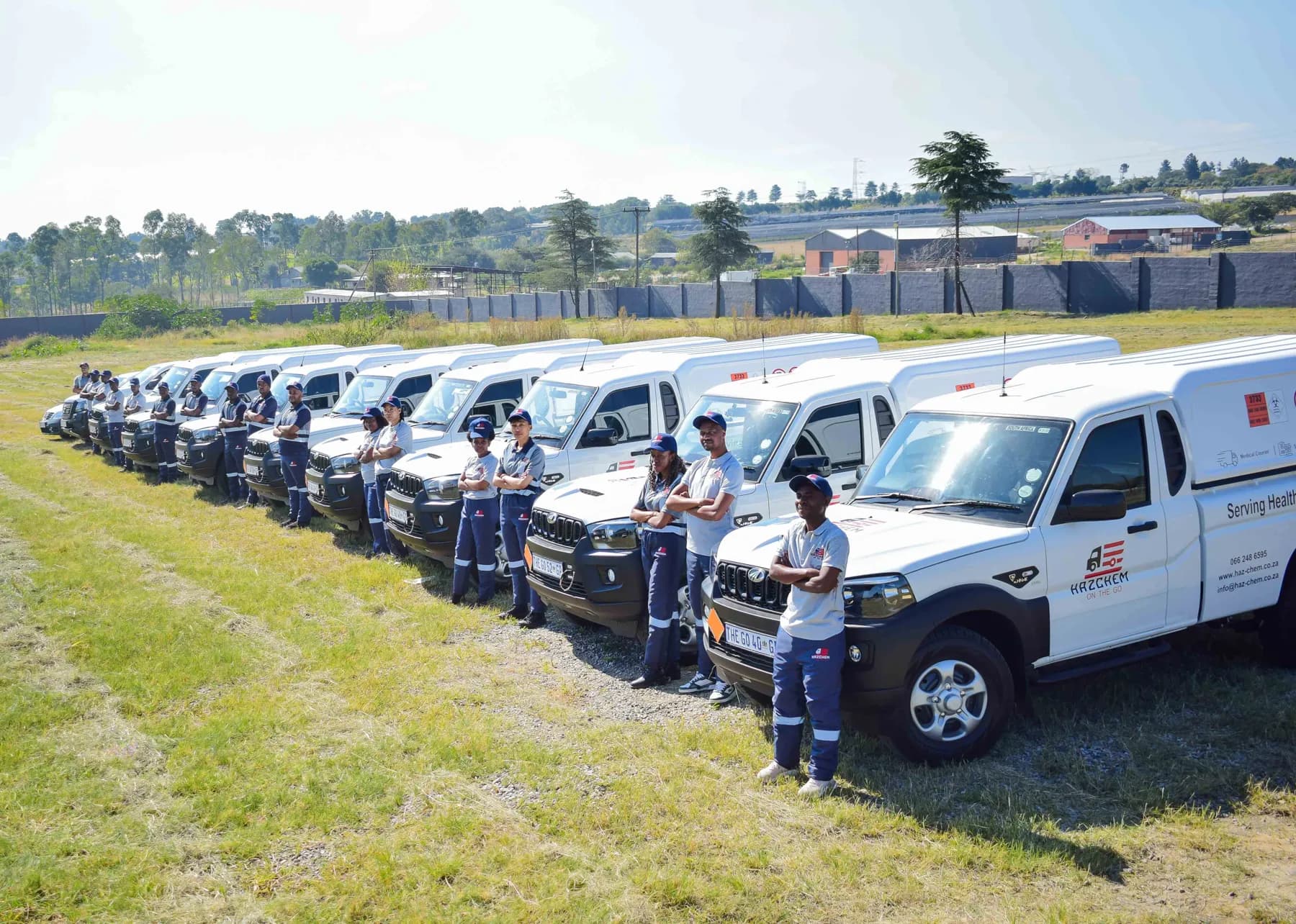 The Hazchem On The Go fleet of branded Mahindra bakkies lined up with crews in navy uniforms
